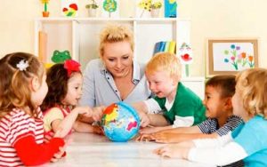 A preschool teacher teaching a group of preschoolers about geography in Delaware Ohio
