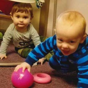 toddlers playing with a ball in a daycare