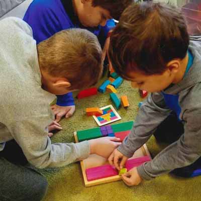 three preschool kids are playing together at a daycare