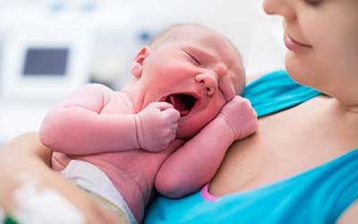 Infant care teacher with baby at daycare in Delaware Ohio