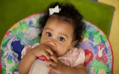 An infant with a bottle under daycare supervision in Ashland Ohio