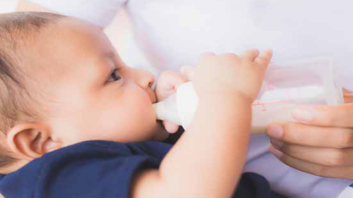 Infant being fed by a bottle daycare Milestones Learning Center Central OH