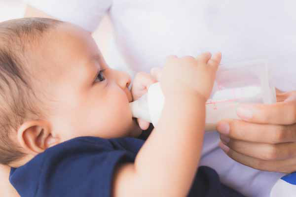 Infant being fed by a bottle daycare Milestones Learning Center Central OH